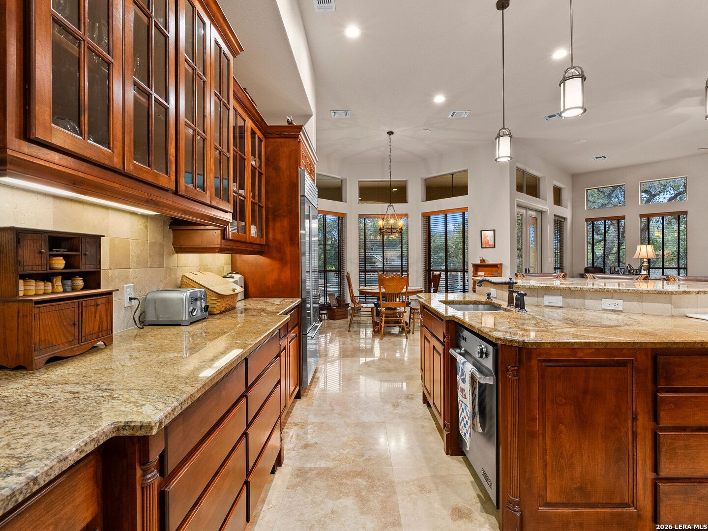 19819 Wild Hollow Garden Ridge, TX 78266 - Photo 19 of 68 a kitchen with stainless steel appliances granite countertop a stove and a sink