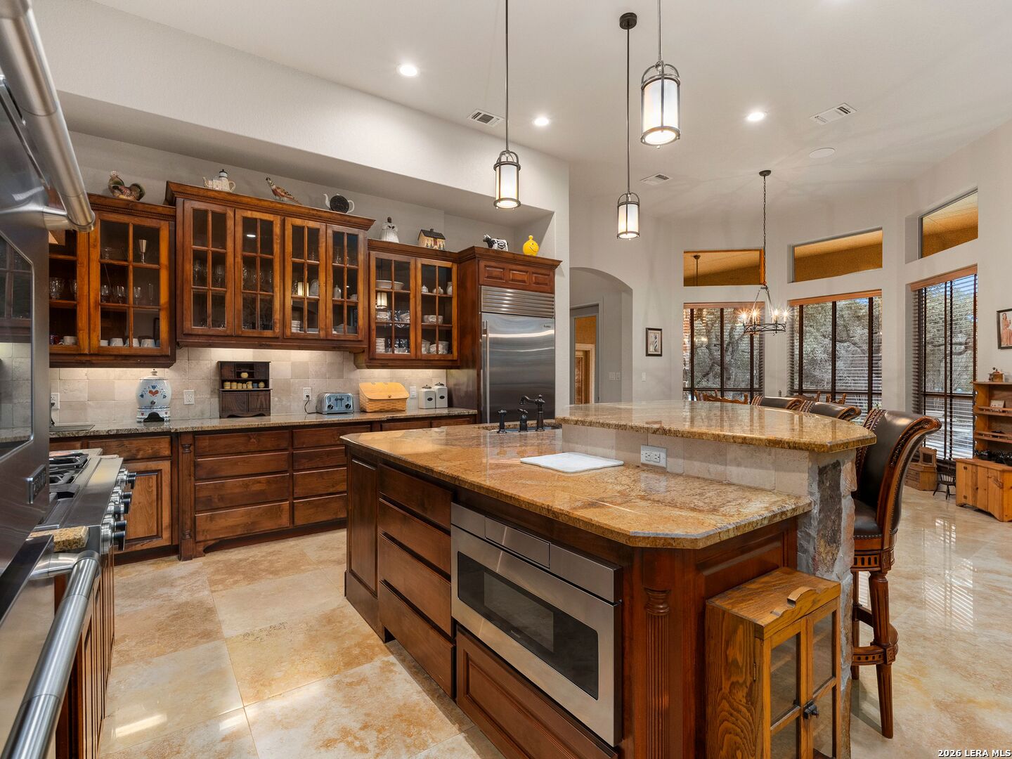 19819 Wild Hollow Garden Ridge, TX 78266 - Photo 21 of 68 a kitchen with stainless steel appliances granite countertop a stove a sink and a refrigerator
