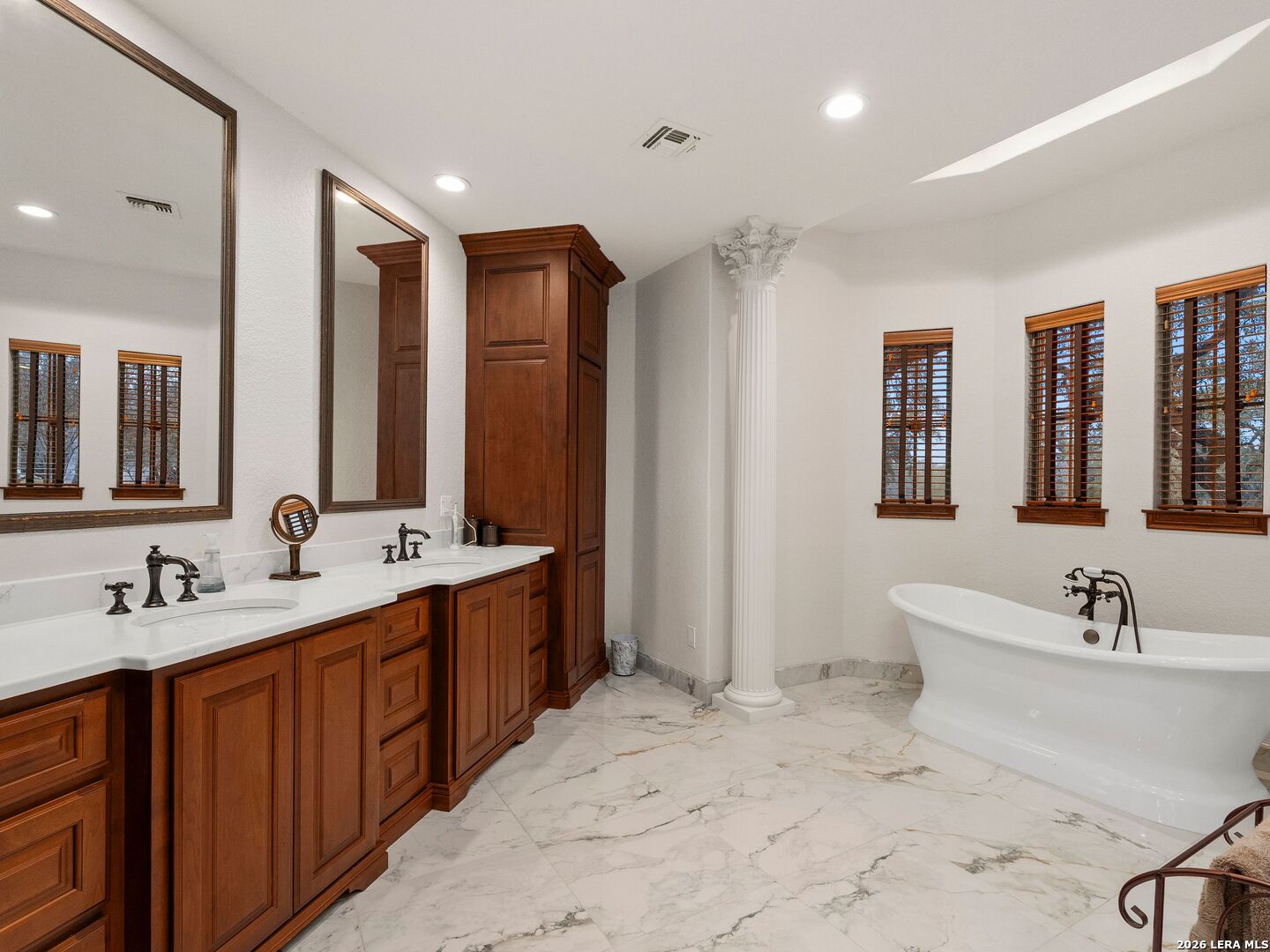 19819 Wild Hollow Garden Ridge, TX 78266 - Photo 28 of 68 a bathroom with a double vanity sink mirror and double