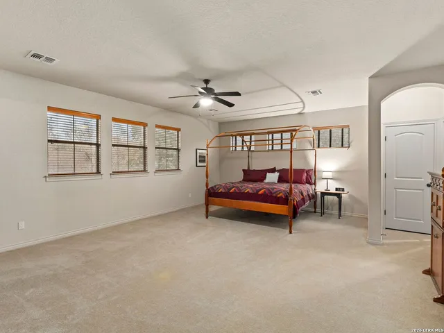 a view of swimming pool with outdoor seating and trees in the background