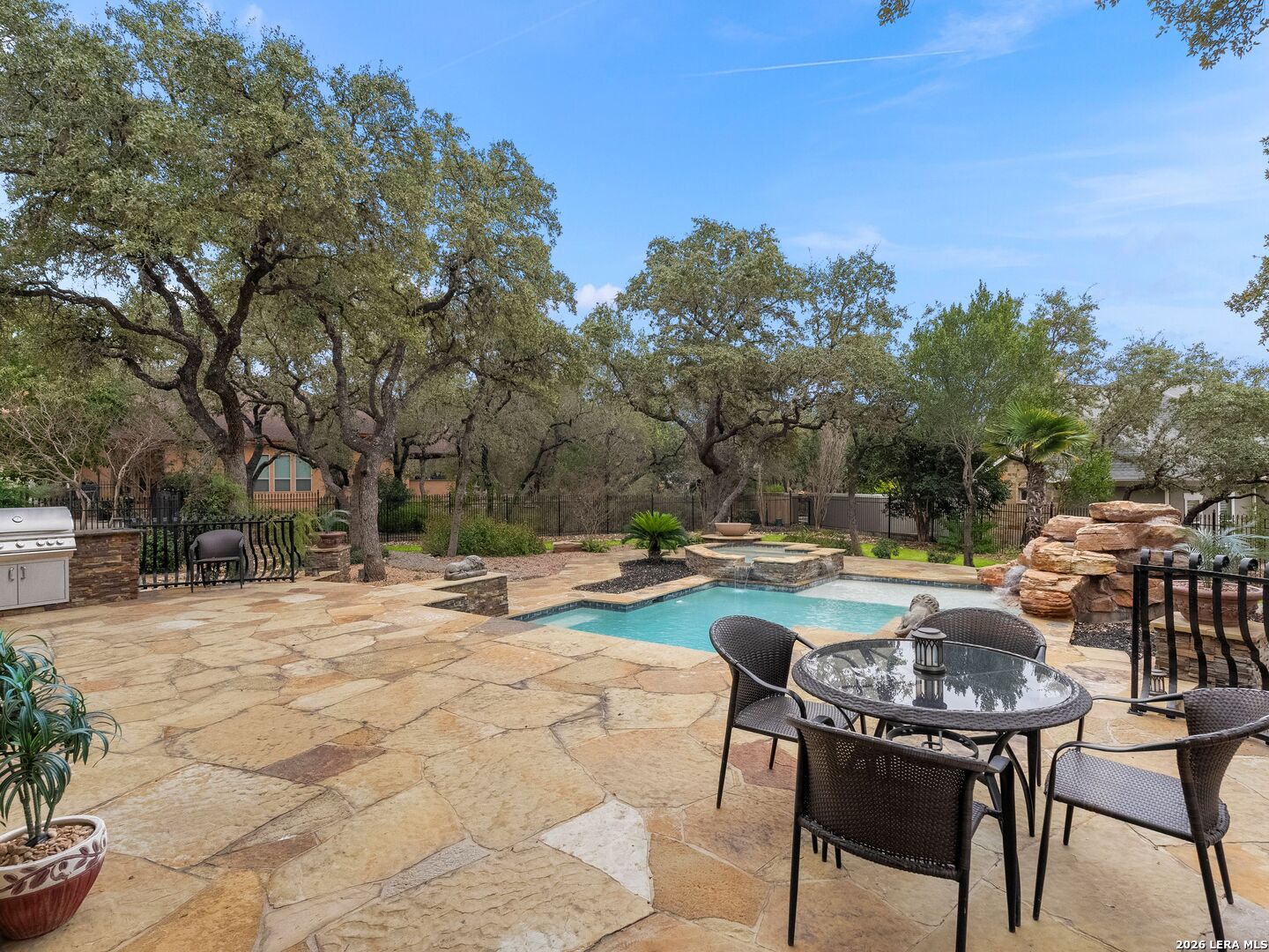 19819 Wild Hollow Garden Ridge, TX 78266 - Photo 49 of 68 a view of swimming pool with outdoor seating and trees in the background