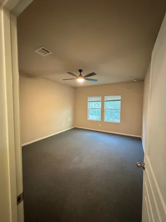 an empty room with a empty space and windows