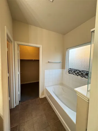 a bathroom with a tub and a shower