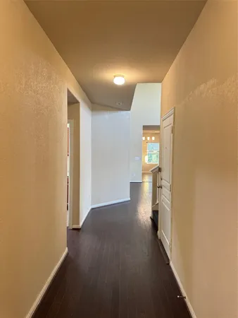 a view of hallway with wooden floor
