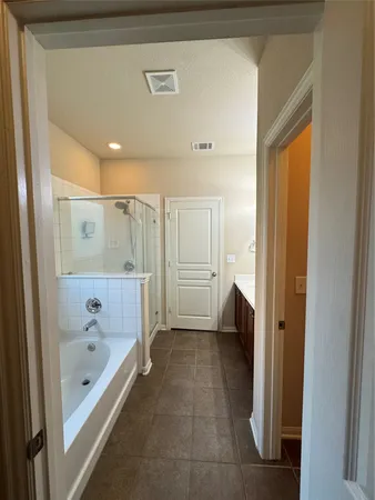 a bathroom with a bathtub and a shower