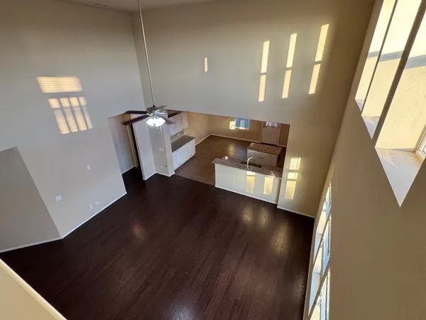 a view of a hallway with wooden floor and stairs
