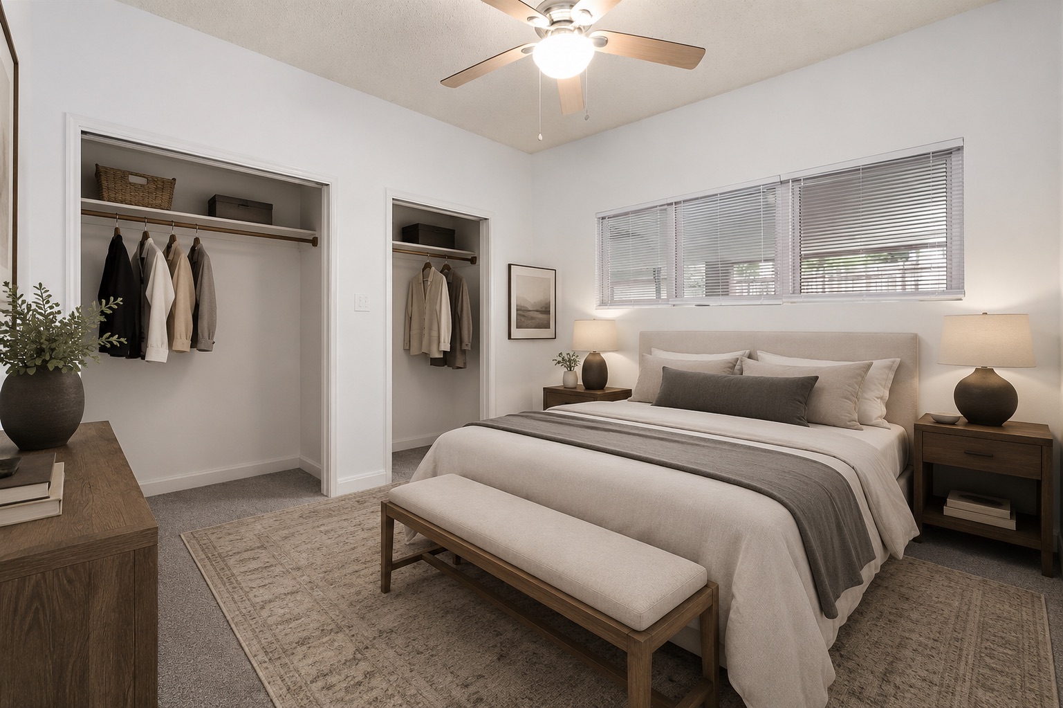 1910 Robbins Place, Unit 103 Austin, TX 78705 - Photo 9 of 16 Bedroom featuring gray carpeting, two open closet spaces with clothing rods and shelving, a ceiling fan with integrated lighting, and a row of three windows with blinds. Virtually staged.