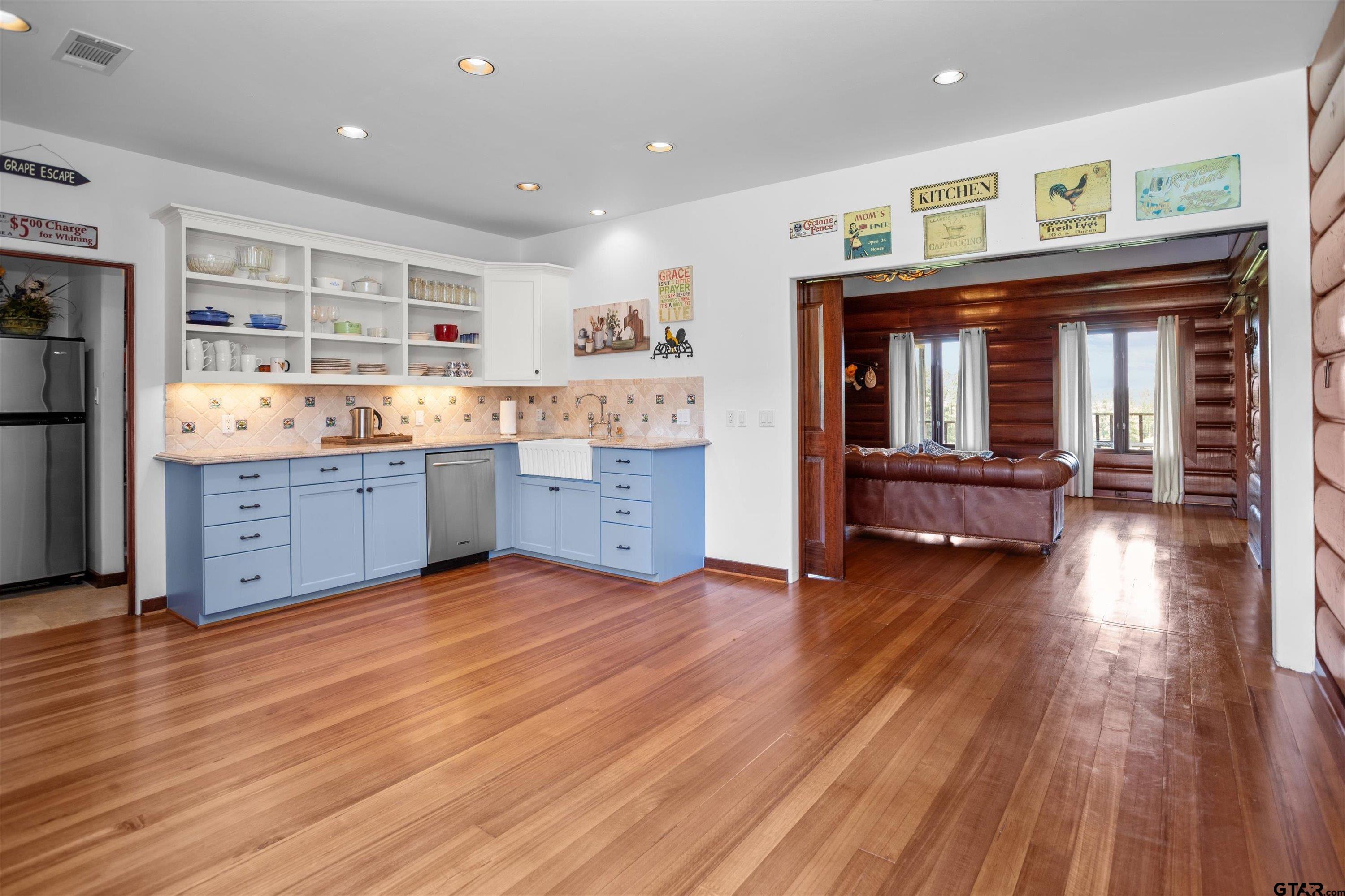 656 Vineyard View Ranch Grapeland, TX 75844 - Photo 14 of 31 a kitchen with granite countertop a stove and a wooden floors