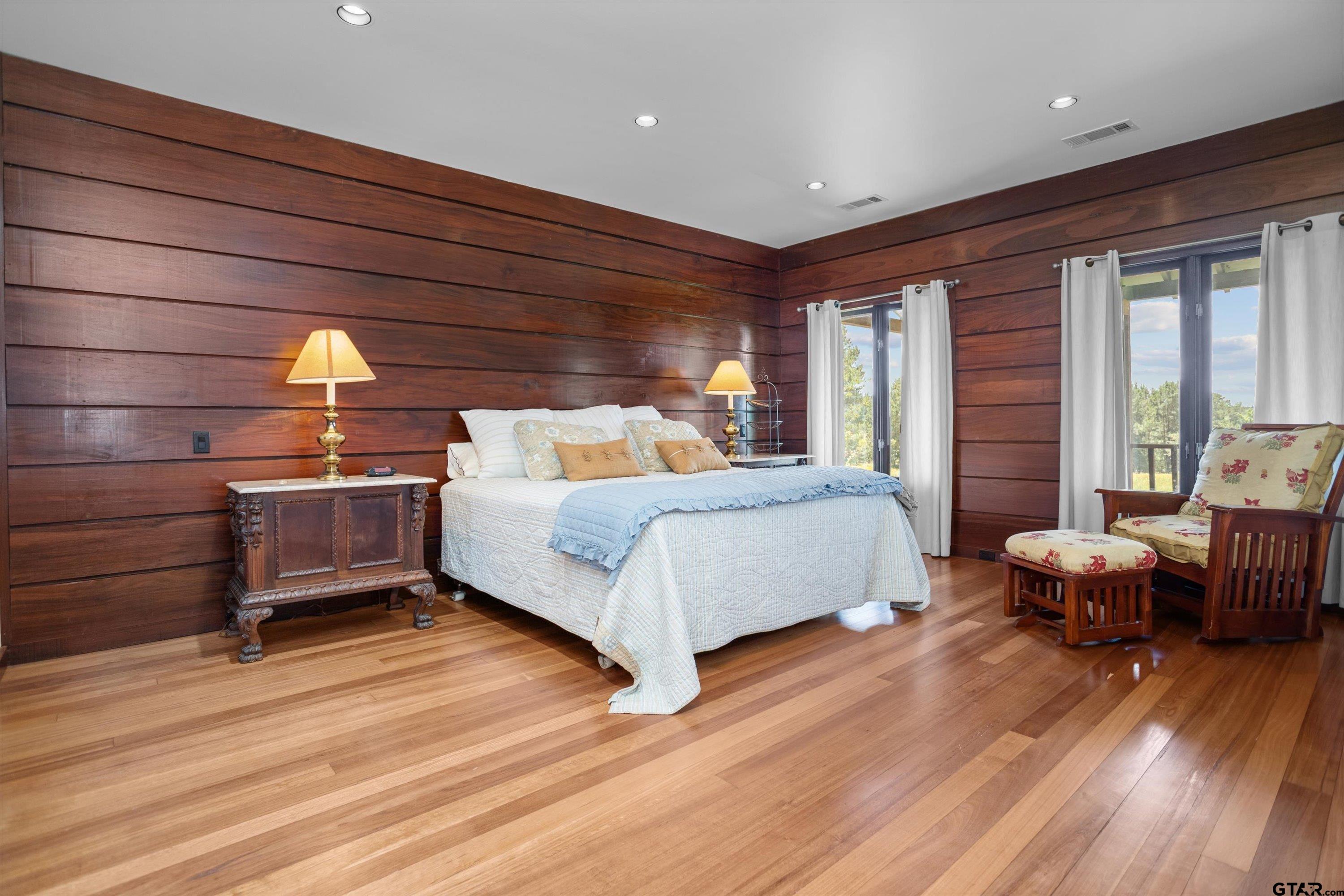 656 Vineyard View Ranch Grapeland, TX 75844 - Photo 19 of 31 a bedroom with a bed and wooden floor