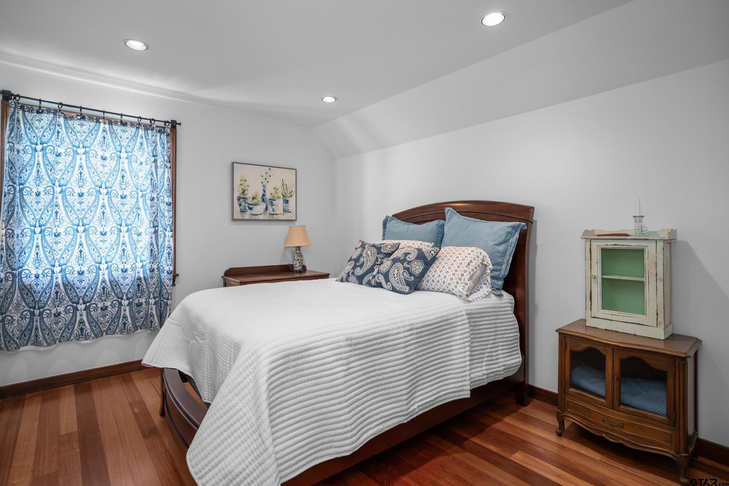 656 Vineyard View Ranch Grapeland, TX 75844 - Photo 23 of 31 a bedroom with a bed and a fireplace