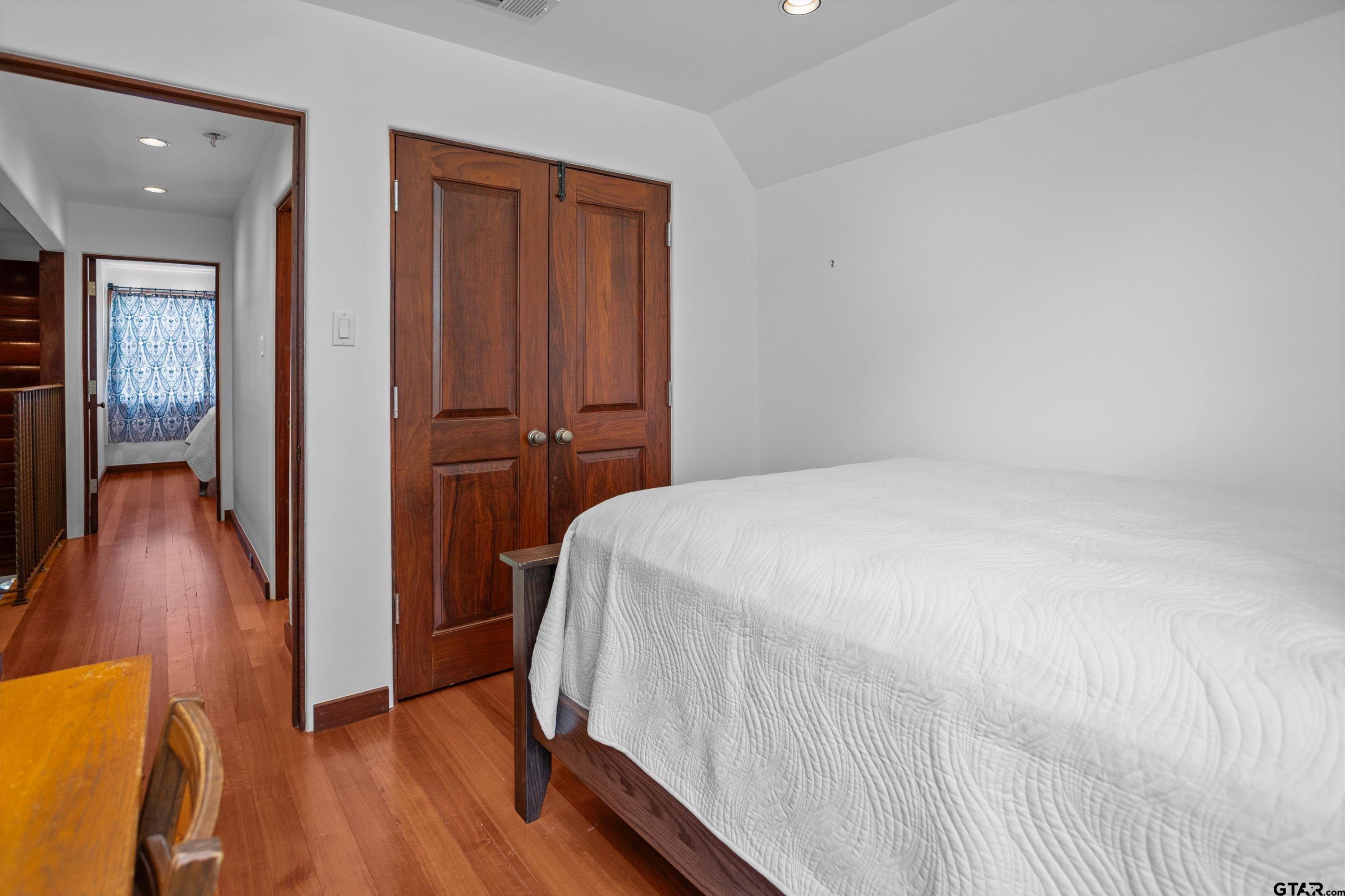 656 Vineyard View Ranch Grapeland, TX 75844 - Photo 26 of 31 a bedroom with a bed and wooden floor