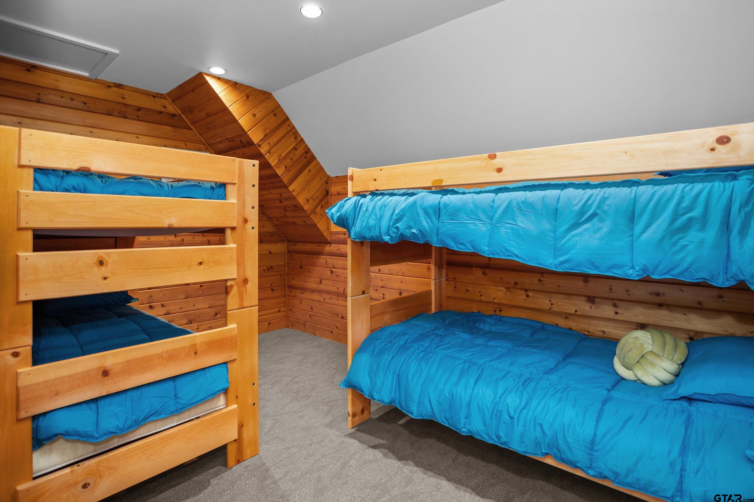 656 Vineyard View Ranch Grapeland, TX 75844 - Photo 27 of 31 a blue bed sitting in a room next to a blue bed