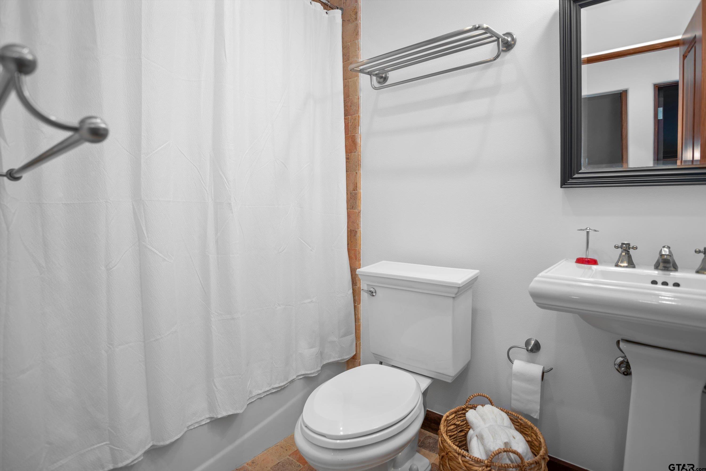 656 Vineyard View Ranch Grapeland, TX 75844 - Photo 28 of 31 a white toilet sitting next to a bathroom sink