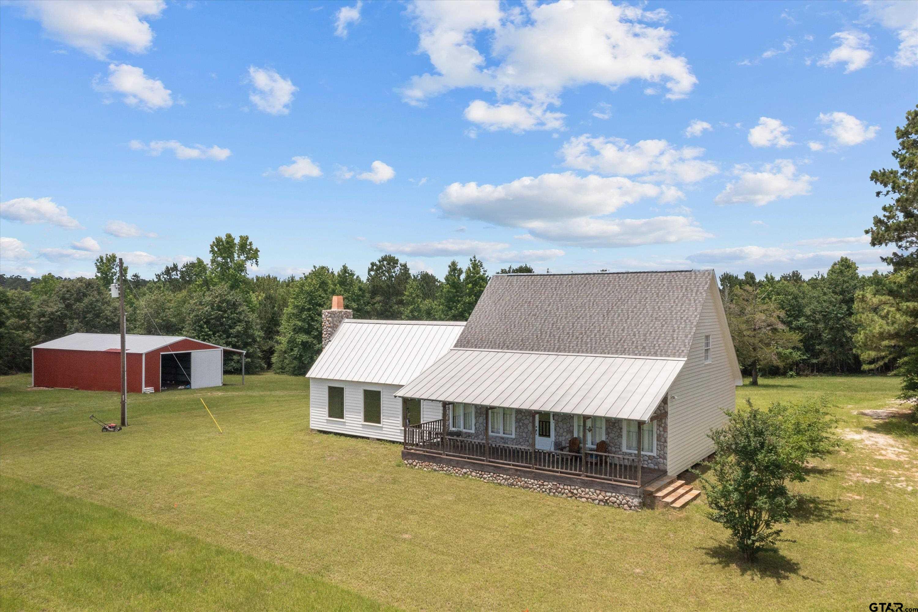 656 Vineyard View Ranch Grapeland, TX 75844 - Photo 3 of 31 a view of a house with pool garden and trees
