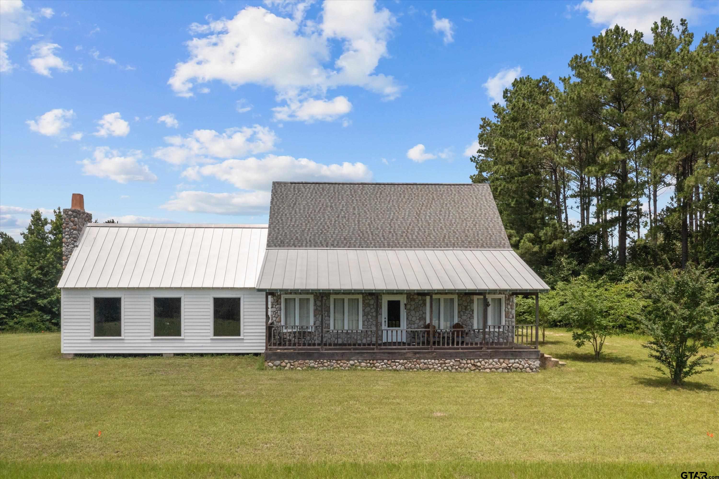 656 Vineyard View Ranch Grapeland, TX 75844 - Photo 5 of 31 a front view of a house with swimming pool having outdoor seating