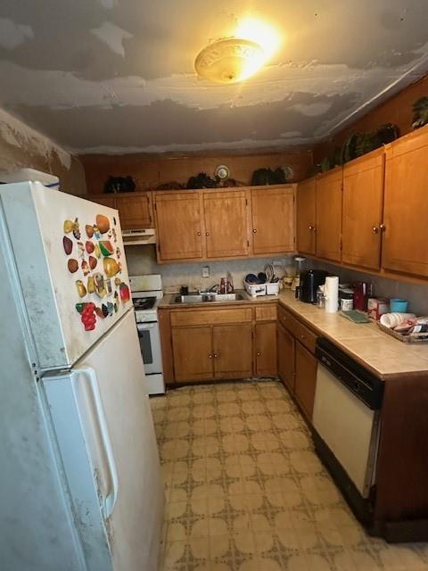 2340 Macon Street Dallas, TX 75215 - Photo 22 of 30 a kitchen with a sink a refrigerator and cabinets