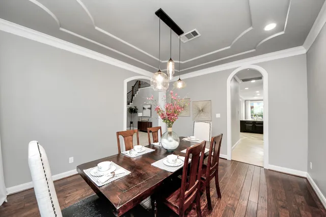 a view of a dining room with furniture and a chandelier