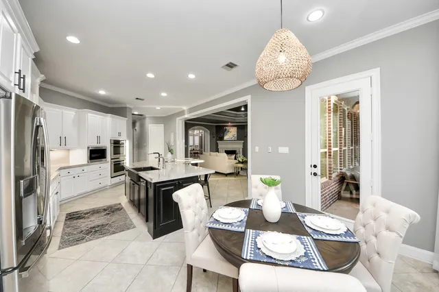 a very nice looking dining room with kitchen island furniture