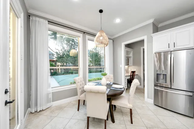 a dining room with furniture a chandelier and a refrigerator