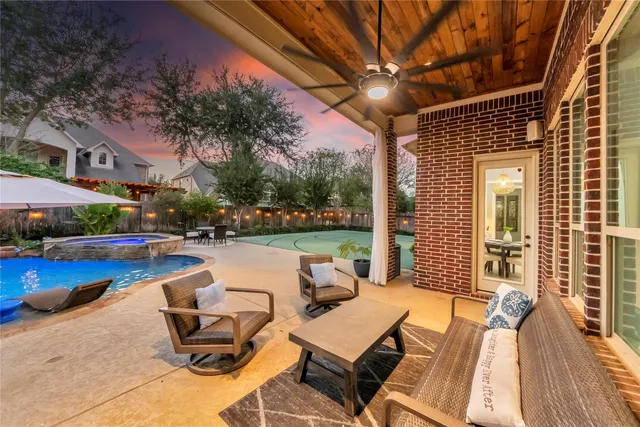 a view of swimming pool with outdoor seating and plants