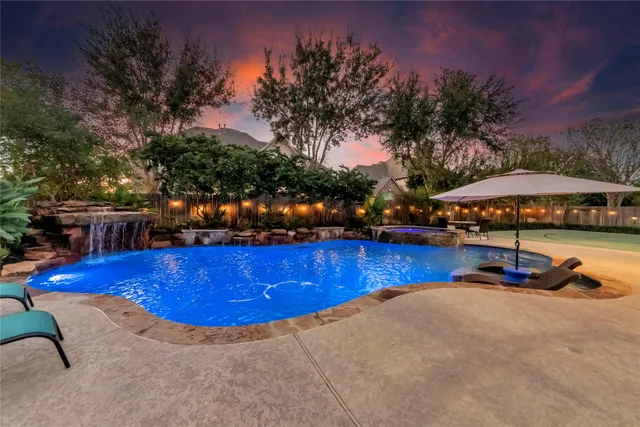 a view of a swimming pool with an outdoor seating and yard