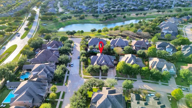 an aerial view of lake and houses with outdoor space