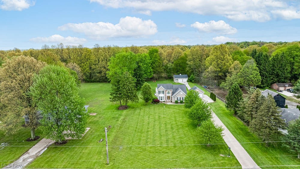 6787 South Palmyra Road Canfield, OH 44406 - Photo 29 of 30 Expansive green lawn surrounds a traditional two-story residence with a light-colored exterior and attached garage