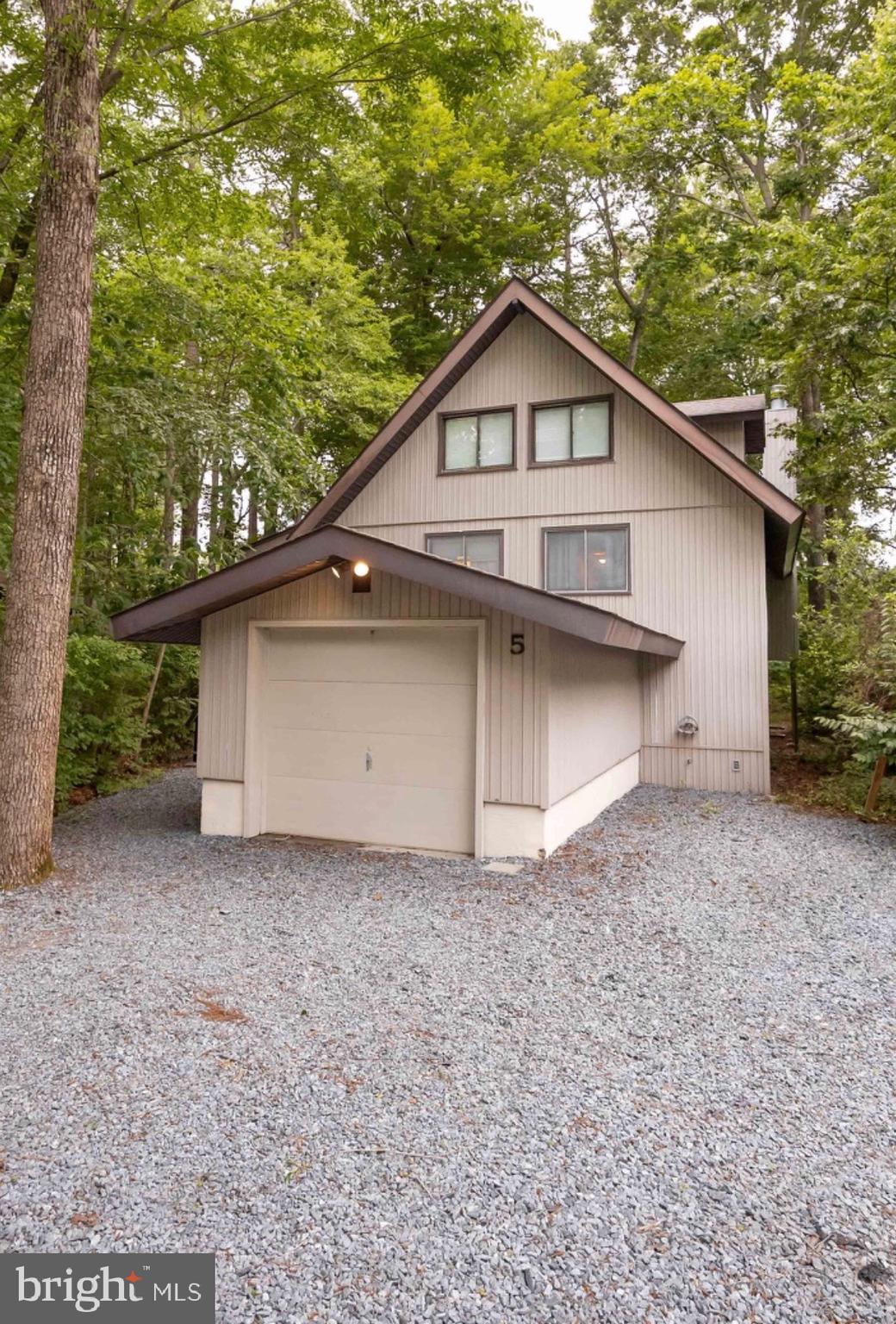 5 Falcon Bridge Road Ocean Pines, MD 21811 - Photo 1 of 59 a house with trees in the background