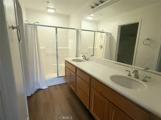 a spacious bathroom with a double vanity sink and a mirror