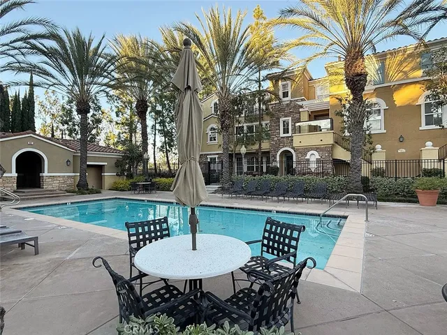 a view of a patio with table and chairs
