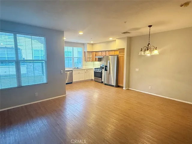 a view of a kitchen with a stove cabinets and wooden floor
