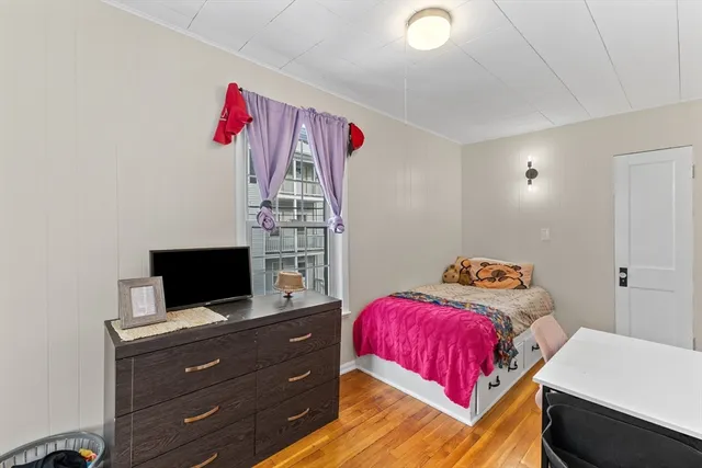 a bedroom with a bed and flat screen tv