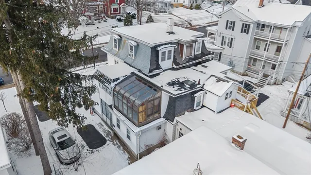 an aerial view of a house with roof deck