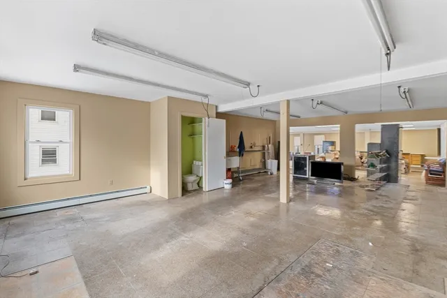 a view of a livingroom with wooden furniture and windows