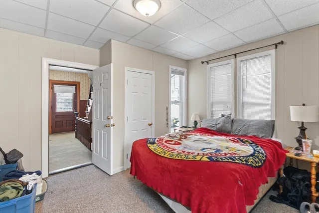 a bedroom with a bed and a mirror