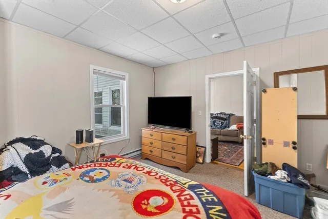 a bedroom with furniture and a flat screen tv