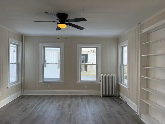 wooden floor in an empty room with a window