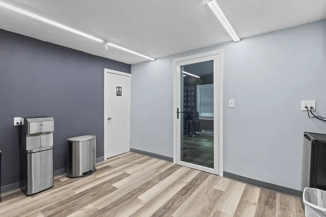 a view of empty room with wooden floor