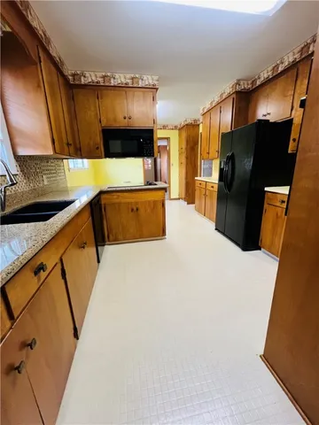a kitchen with stainless steel appliances a refrigerator and a microwave