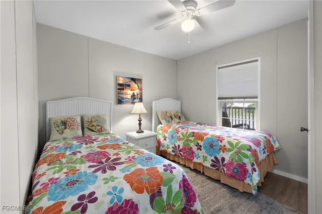 a bedroom with two beds and a baby crib