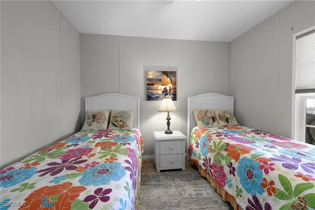 a bedroom with two beds and a baby crib