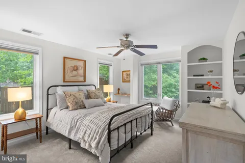 a bedroom with a bed couch and a window
