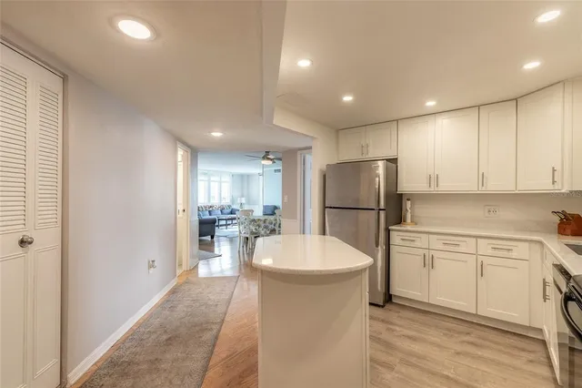 a kitchen with a sink stainless steel appliances and white cabinets