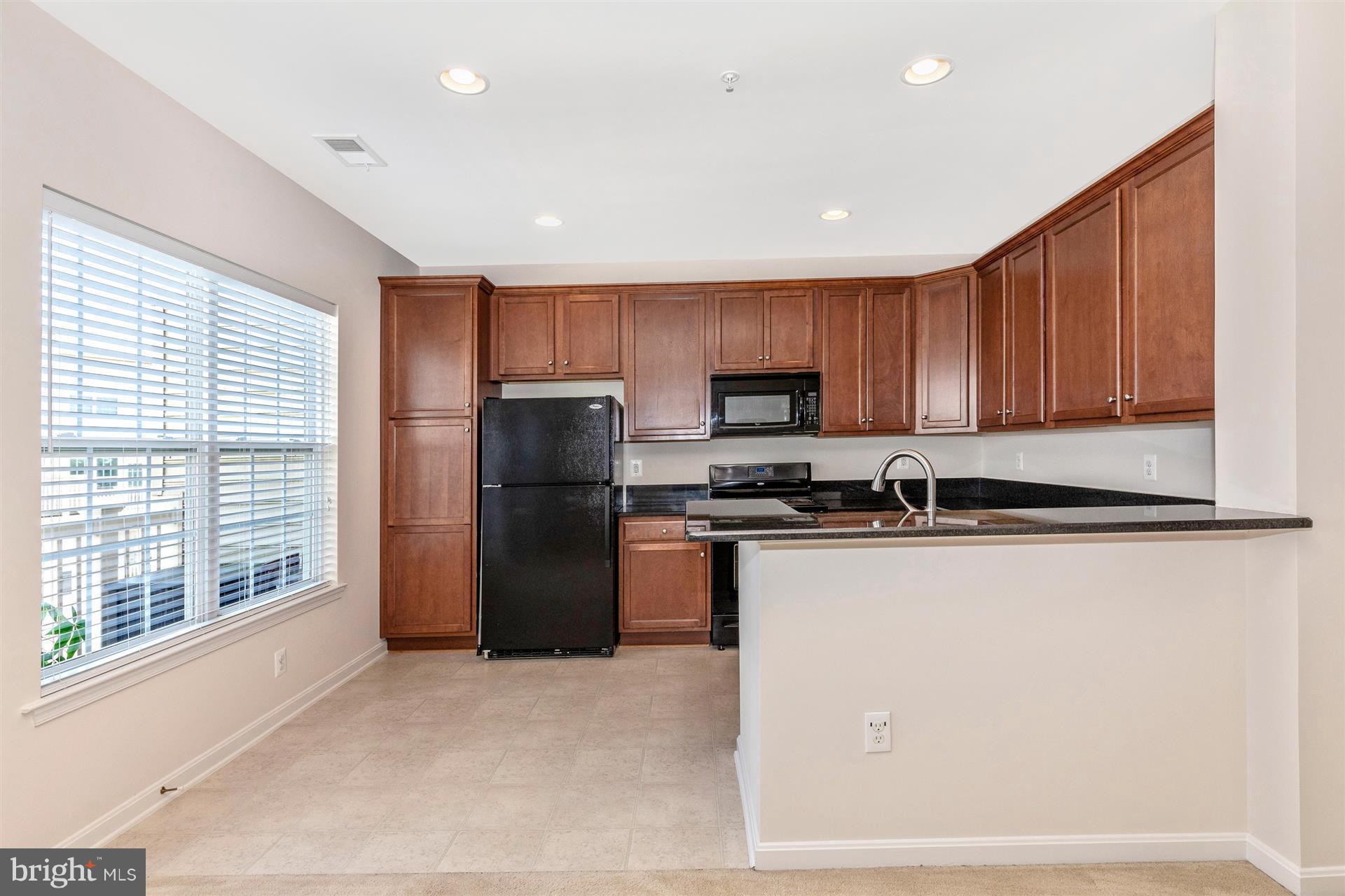 1832 Monocacy View Circle Frederick, MD 21701 - Photo 11 of 30 a kitchen with stainless steel appliances granite countertop a refrigerator a stove a sink and a microwave