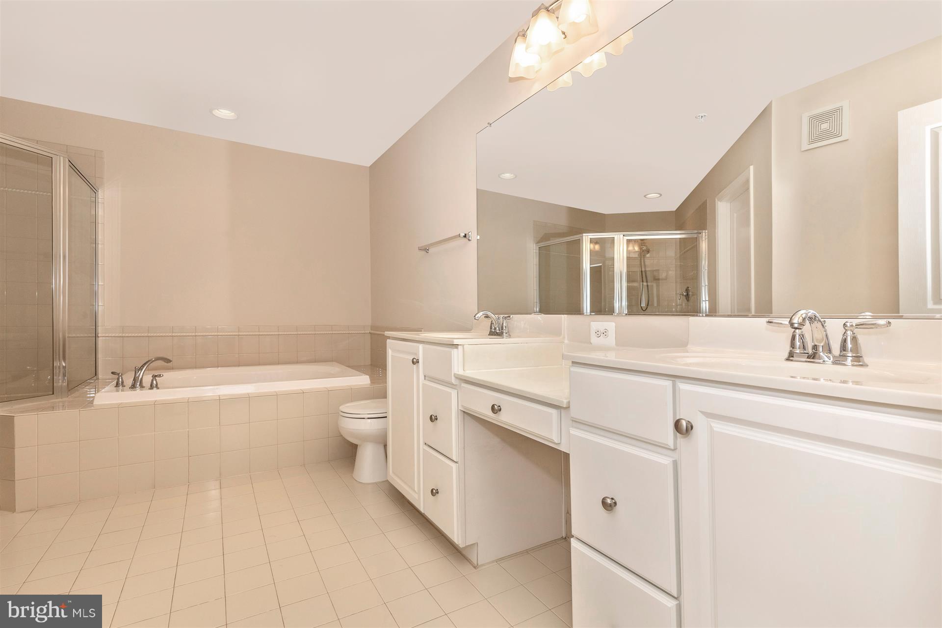 1832 Monocacy View Circle Frederick, MD 21701 - Photo 17 of 30 a spacious bathroom with a granite countertop sink a toilet a mirror and bathtub