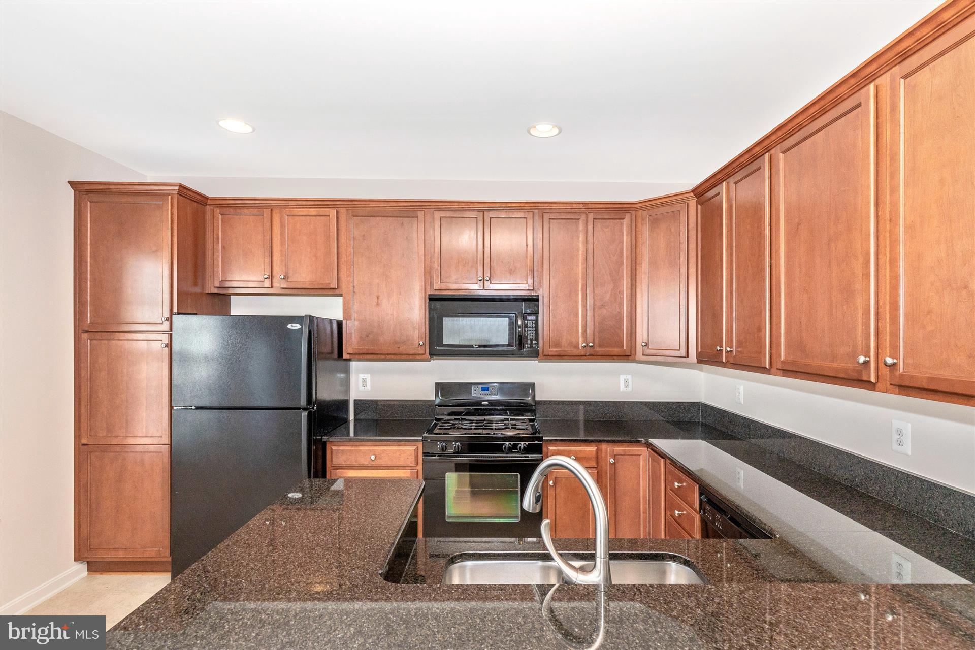 1832 Monocacy View Circle Frederick, MD 21701 - Photo 10 of 30 a kitchen with granite countertop a refrigerator and microwave