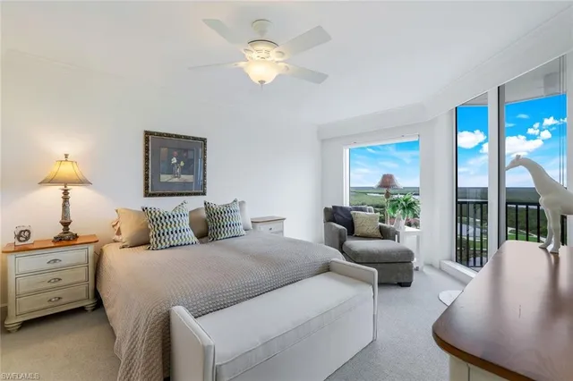 a bedroom with a balcony a bed and a chandelier