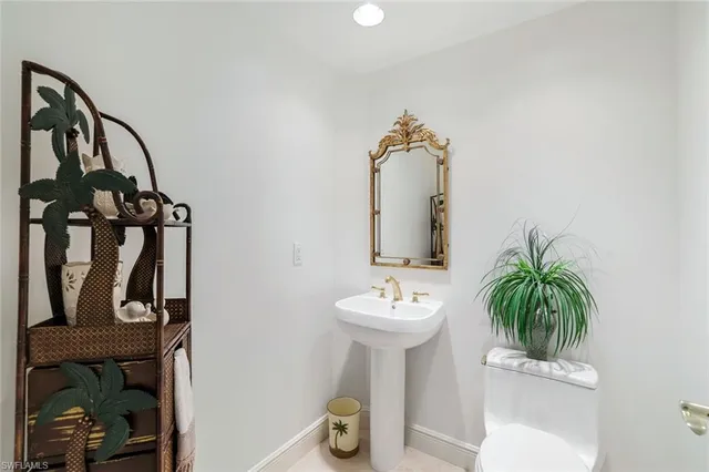 a bathroom with a sink toilet and mirror