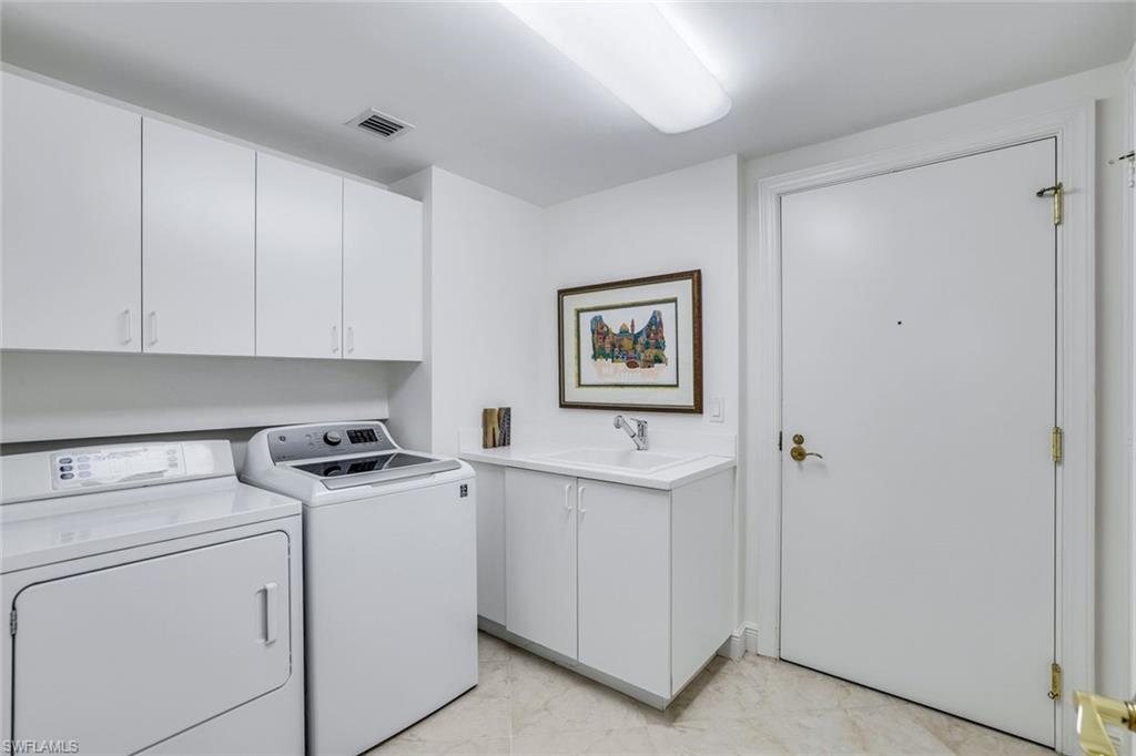1060 Borghese Lane, Unit 1005 Naples, FL 34114 - Photo 21 of 38 a view of a storage and utility room with closet dryer