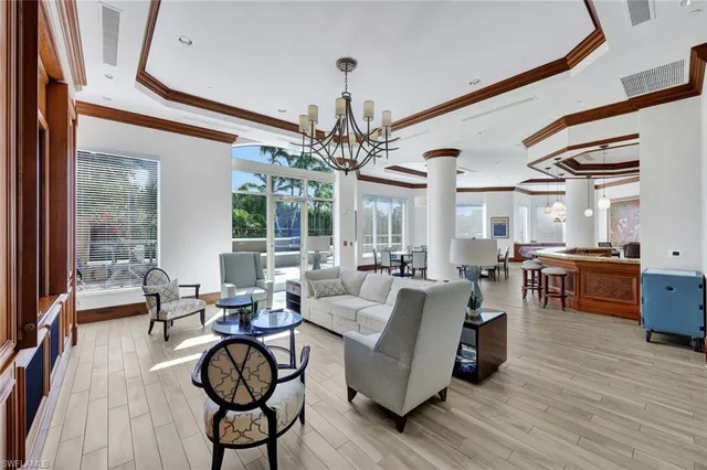 a living room with furniture and a chandelier